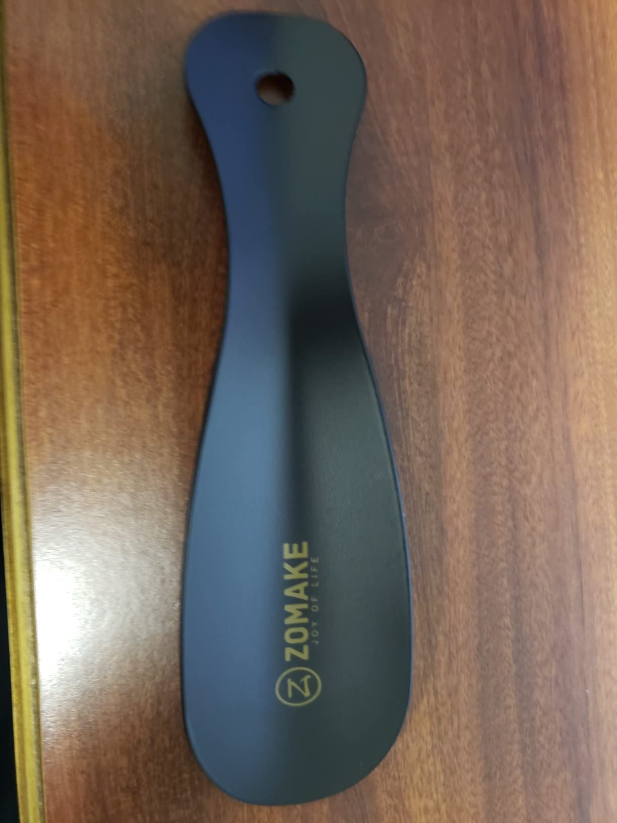 ZOMAKE shoe horn detail showing smooth metal construction and ergonomic curve design