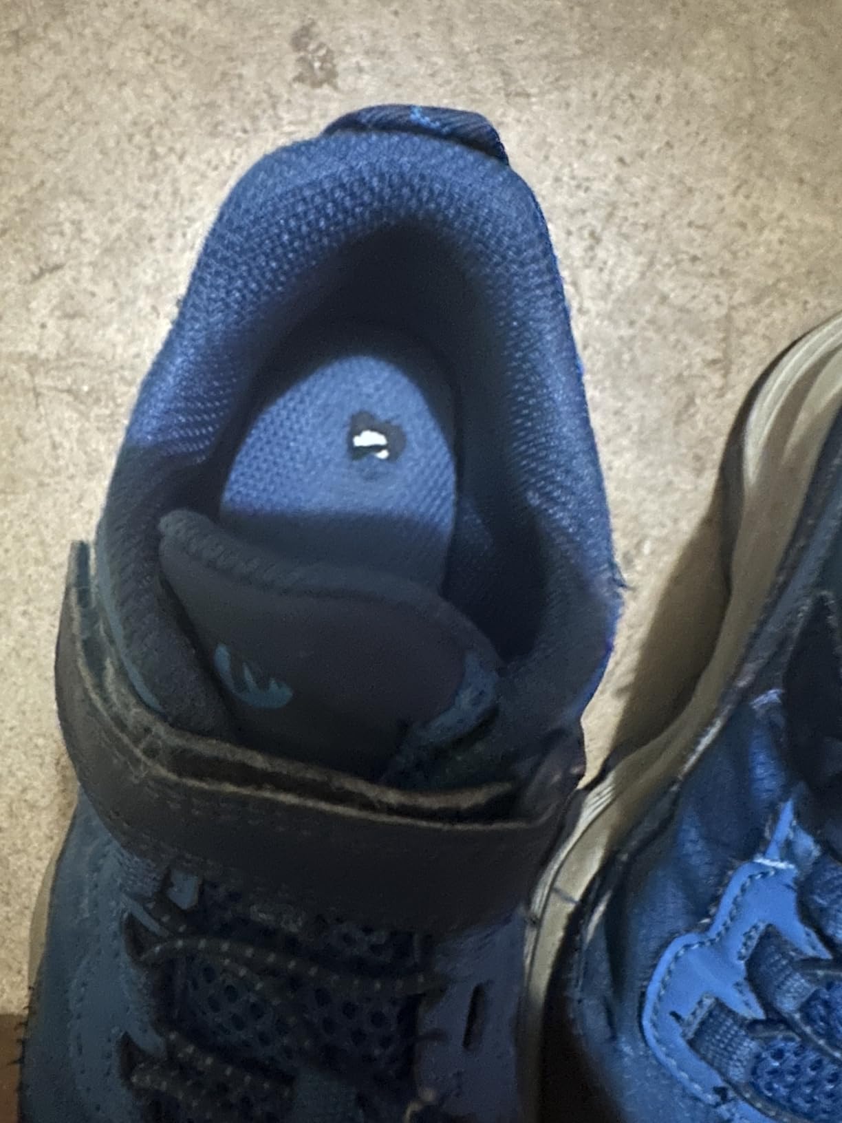 Close-up showing construction quality and seam details of Merrell kids hiking shoe