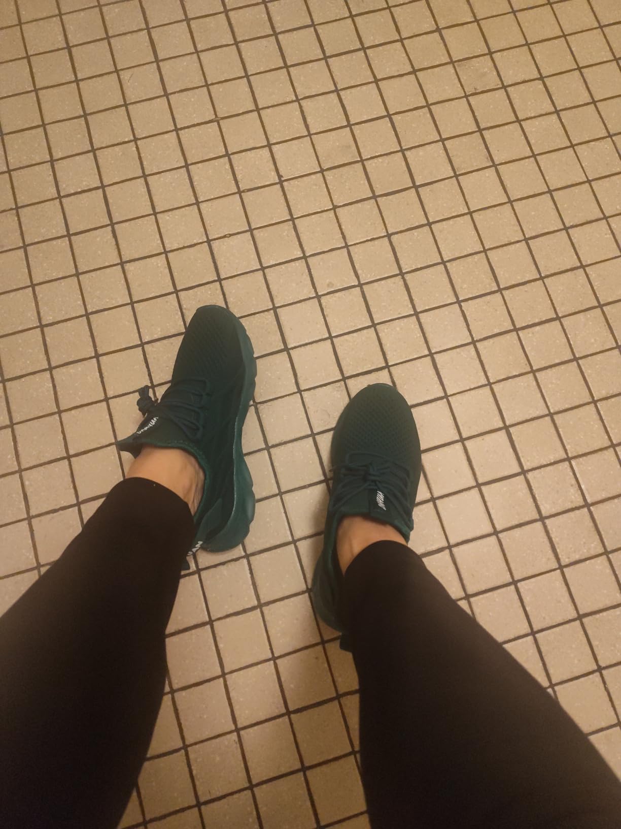 Full shoe profile showing emerald green colorway and overall design aesthetic