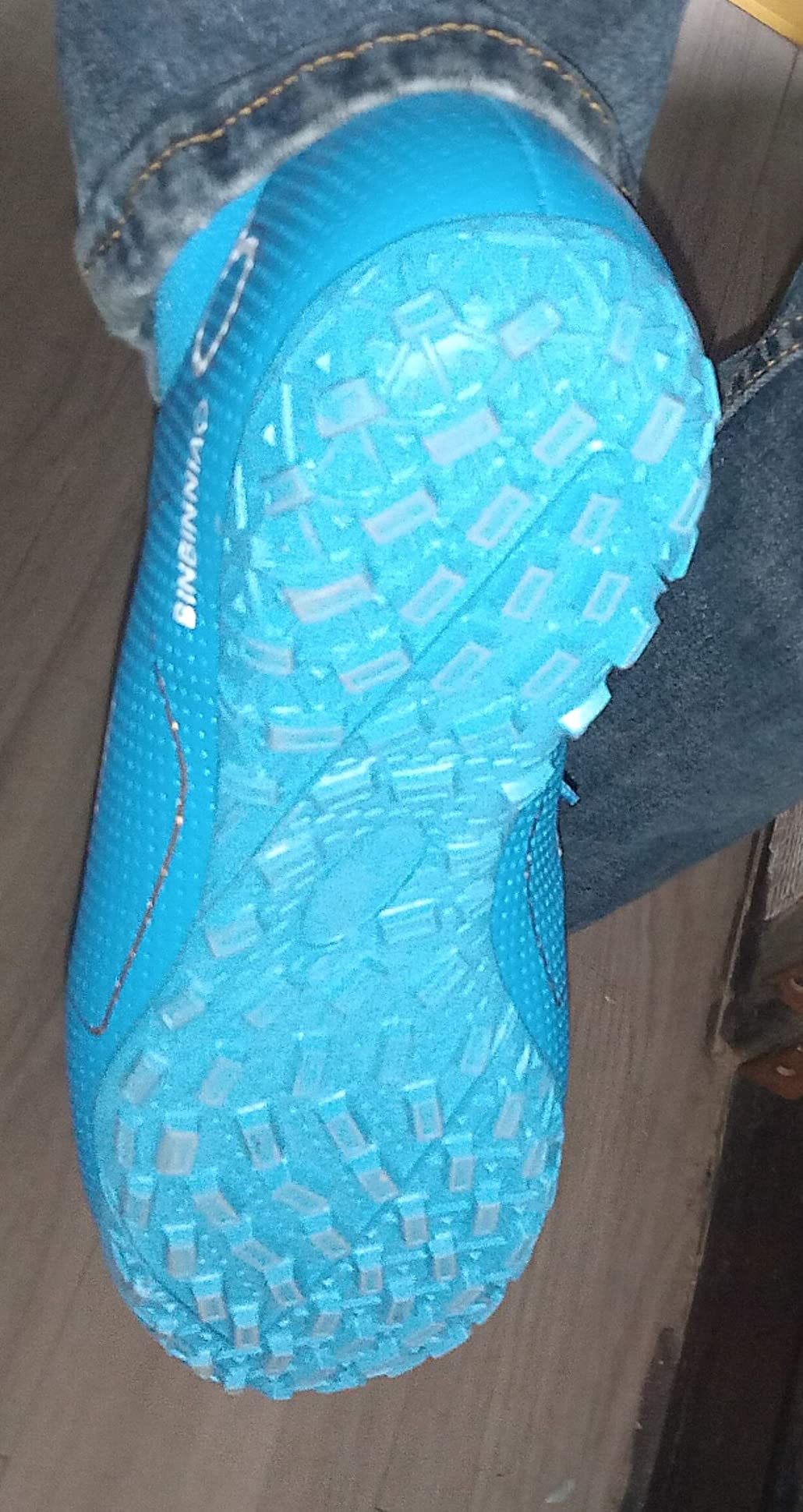 High-top soccer boots in action on field
