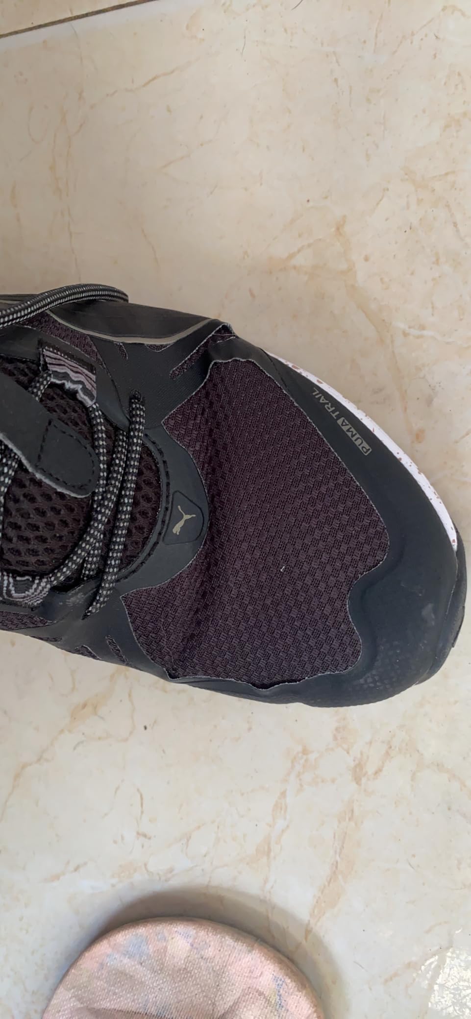 PUMA Reflect Lite Trail on rocky trail terrain showing grip and stability in real hiking conditions