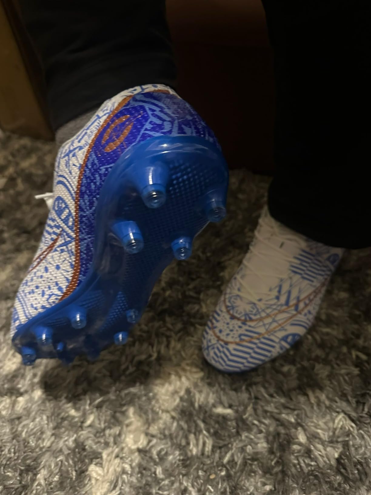 Soccer cleats sole showing FG AG TF stud pattern for multi-surface performance