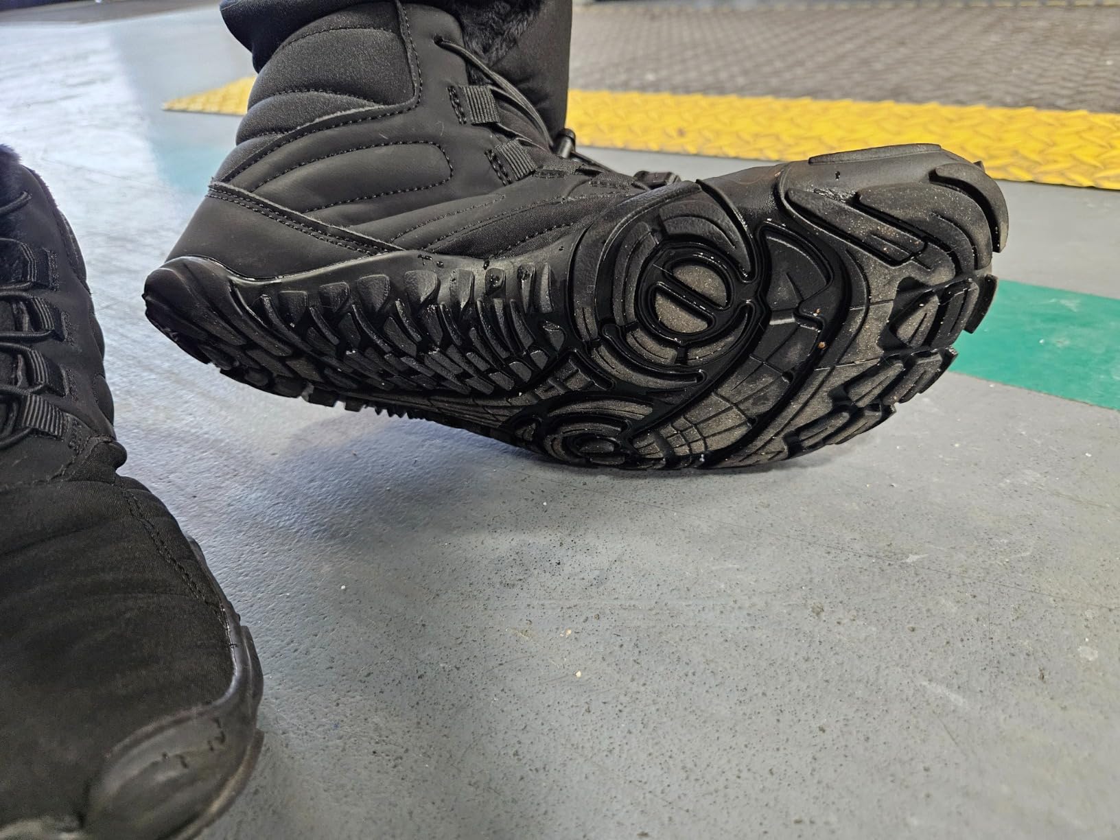 Close-up view of Winter Hike Barefoot Boots construction and lacing system