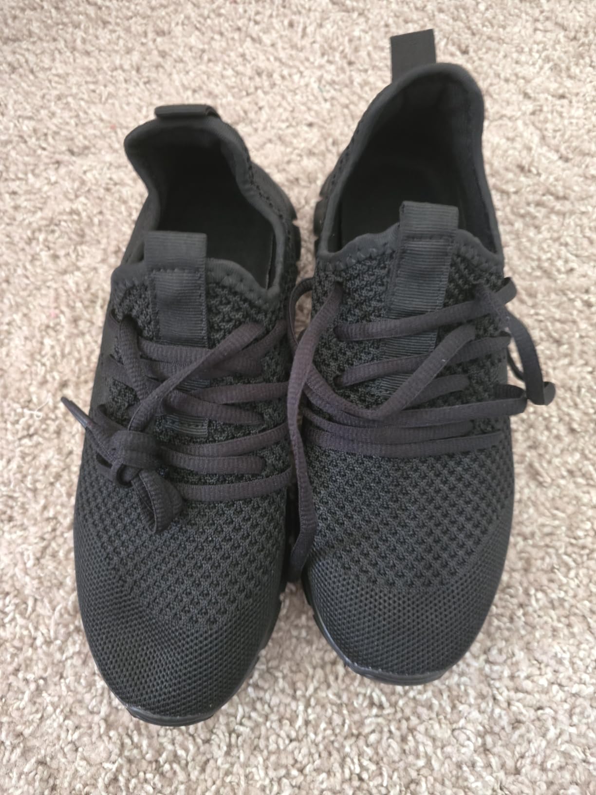 White mesh athletic sneakers showing arch support and durable rubber outsole design