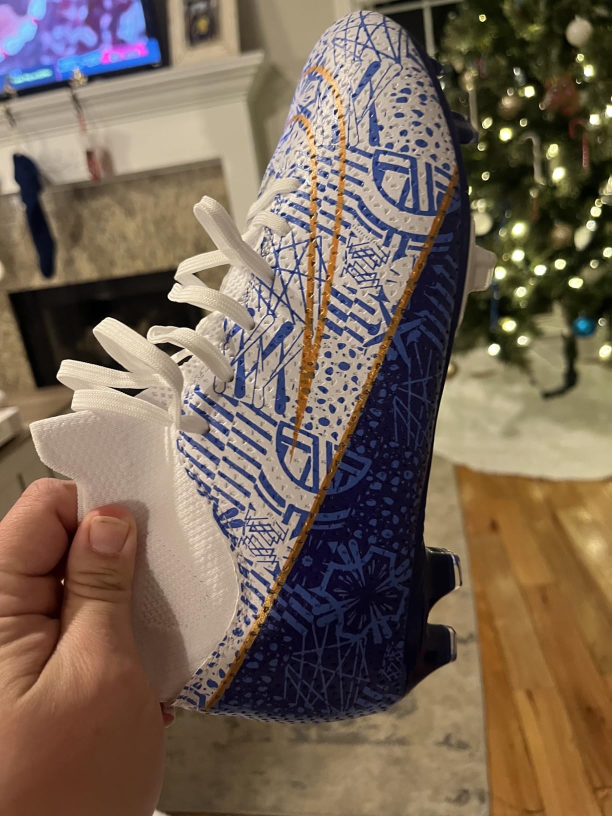 High ankle soccer cleats showing knitted sock design and lace-up closure system