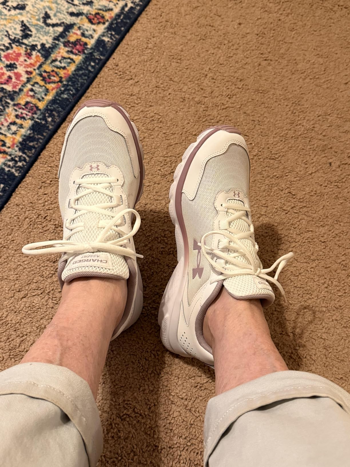 Under Armour Charged Assert 9 white and mauve colorway showing elegant design