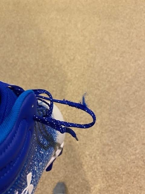 Multiple angle view of Under Armour Spotlight football cleats showing construction details and durability features