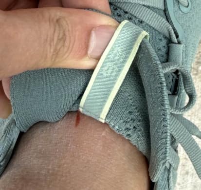 Close-up of ASICS Gel-Nimbus 26 engineered knit upper showing soft mesh construction and lacing system
