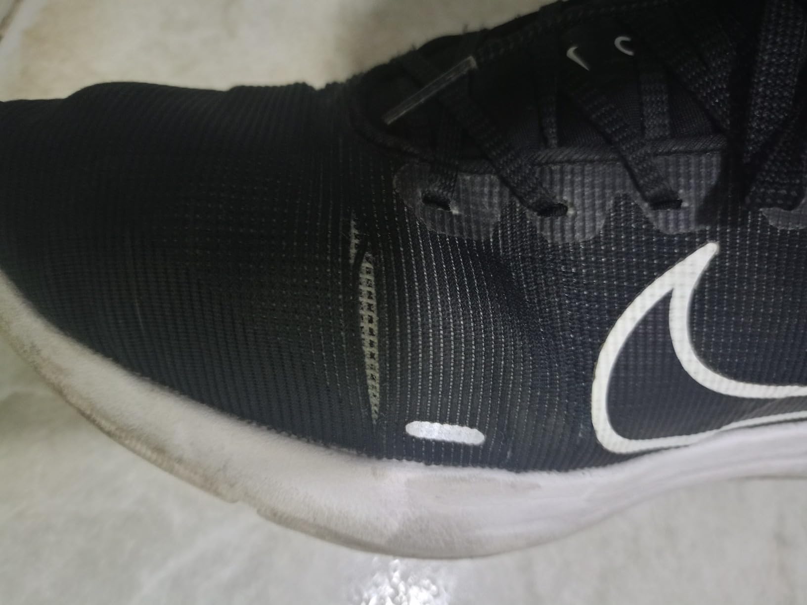 Nike Downshifter 12 sole pattern showing rubber traction design and wear patterns after testing