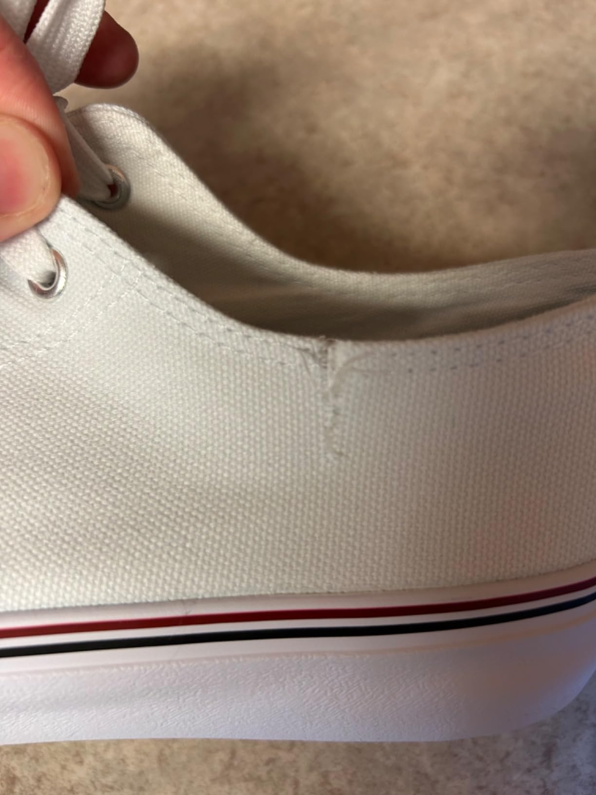 FRACORA white canvas sneakers showing potential quality control issues to be aware of