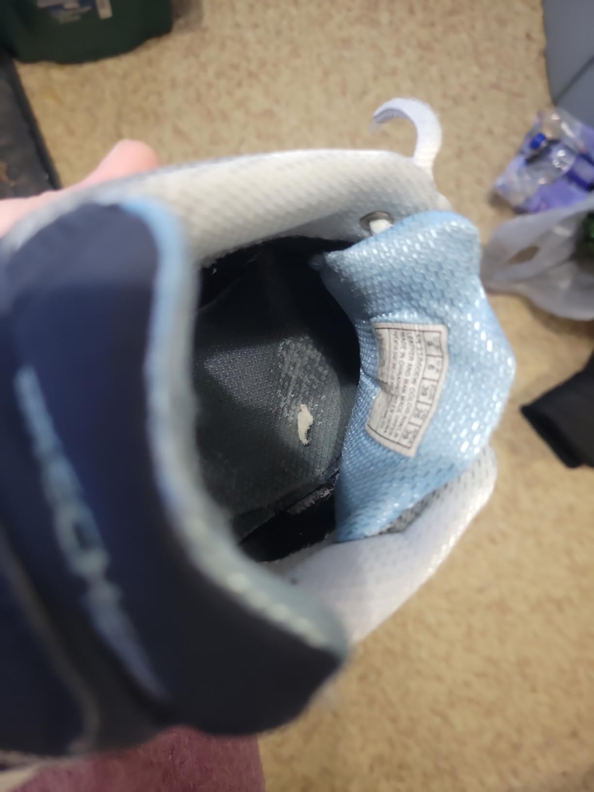 Image showing the inside heel of a Skechers D'Lite shoe with visible wear and tear after six months.