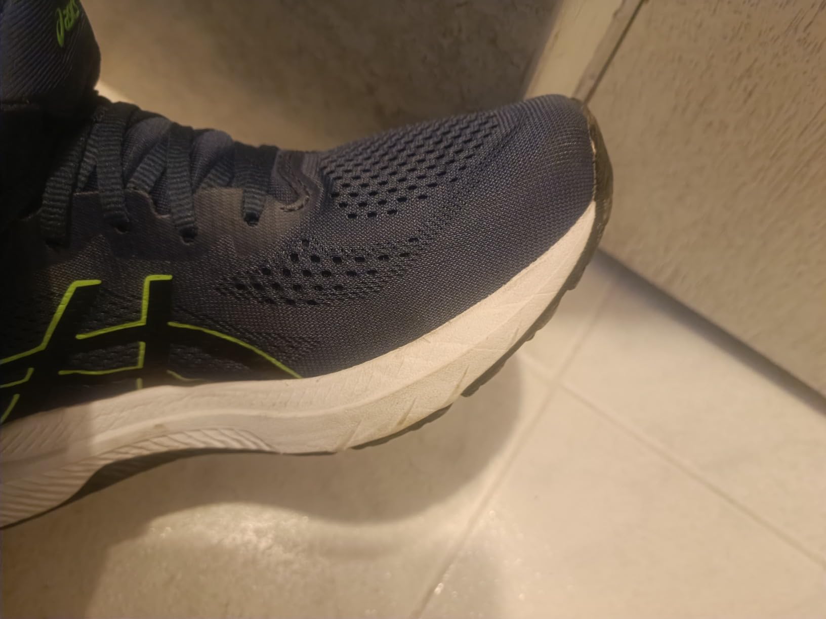 ASICS GT-1000 12 showing size comparison and upper mesh construction detail