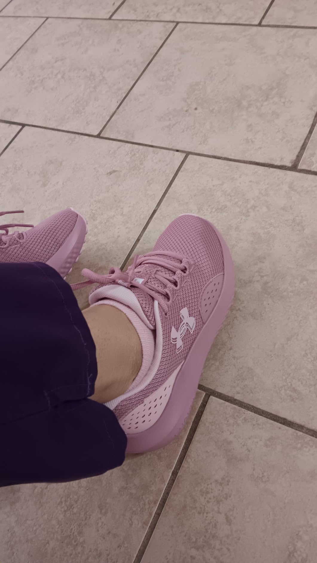 Under Armour Charged Surge 4 pink blush colorway showing breathable mesh upper construction and lace-up design