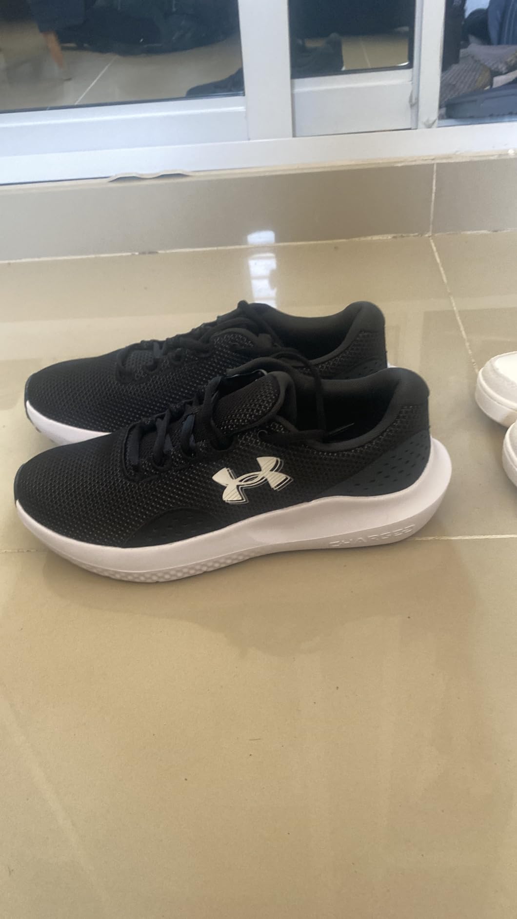 Close-up view of Under Armour Charged Surge 4 showing mesh upper construction and lacing system detail