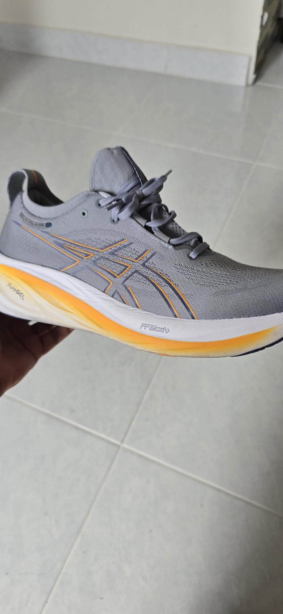 ASICS Gel-Nimbus 26 in action during road running showing stability and cushioning performance