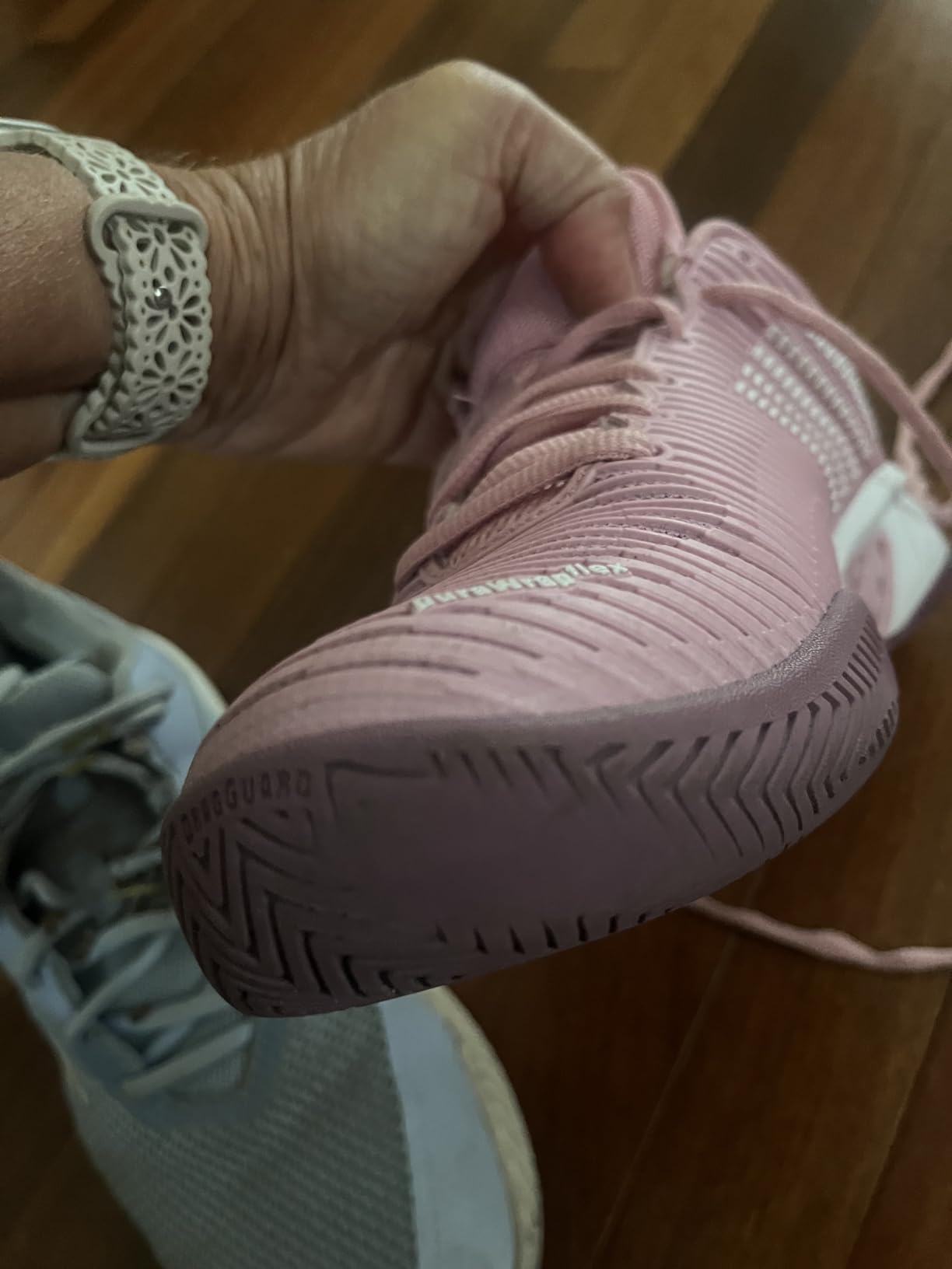 Comparison of K-Swiss vs Adidas tennis shoes showing sole construction and toe drag protection differences