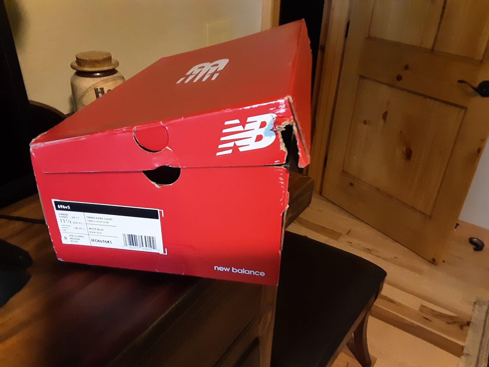 New Balance 696 V5 showing side view with mesh ventilation panels and support structure