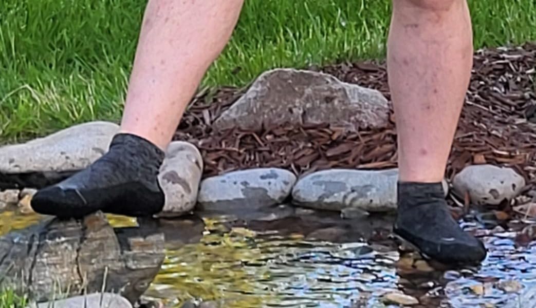 Final lifestyle shot of WHITIN barefoot sock shoes in real-world use setting