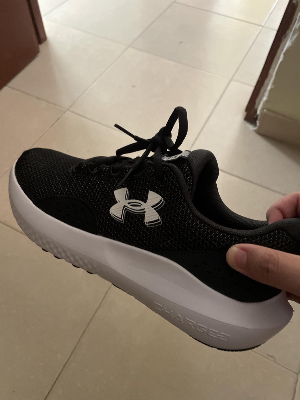 Under Armour Men's Charged Surge 4 sneaker showing breathable mesh upper and synthetic overlays design