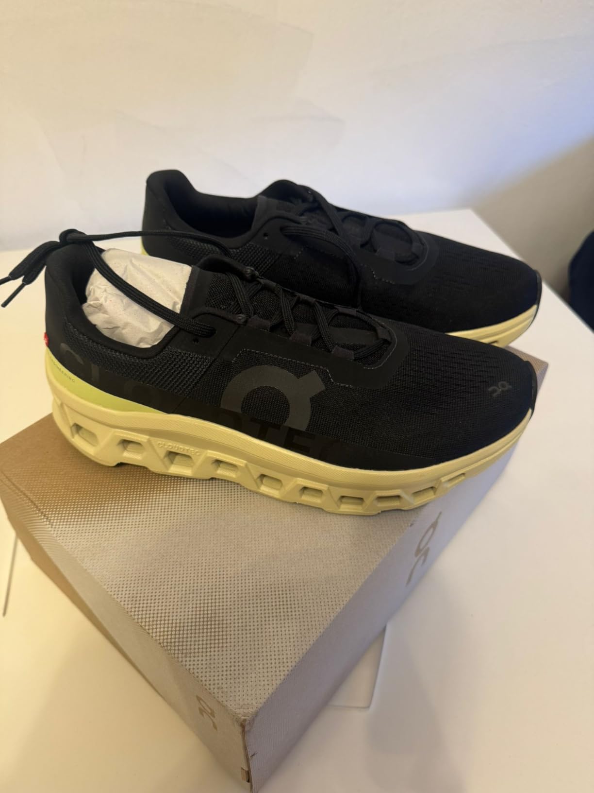 Close-up view of On Cloudmonster upper mesh construction and lacing system details