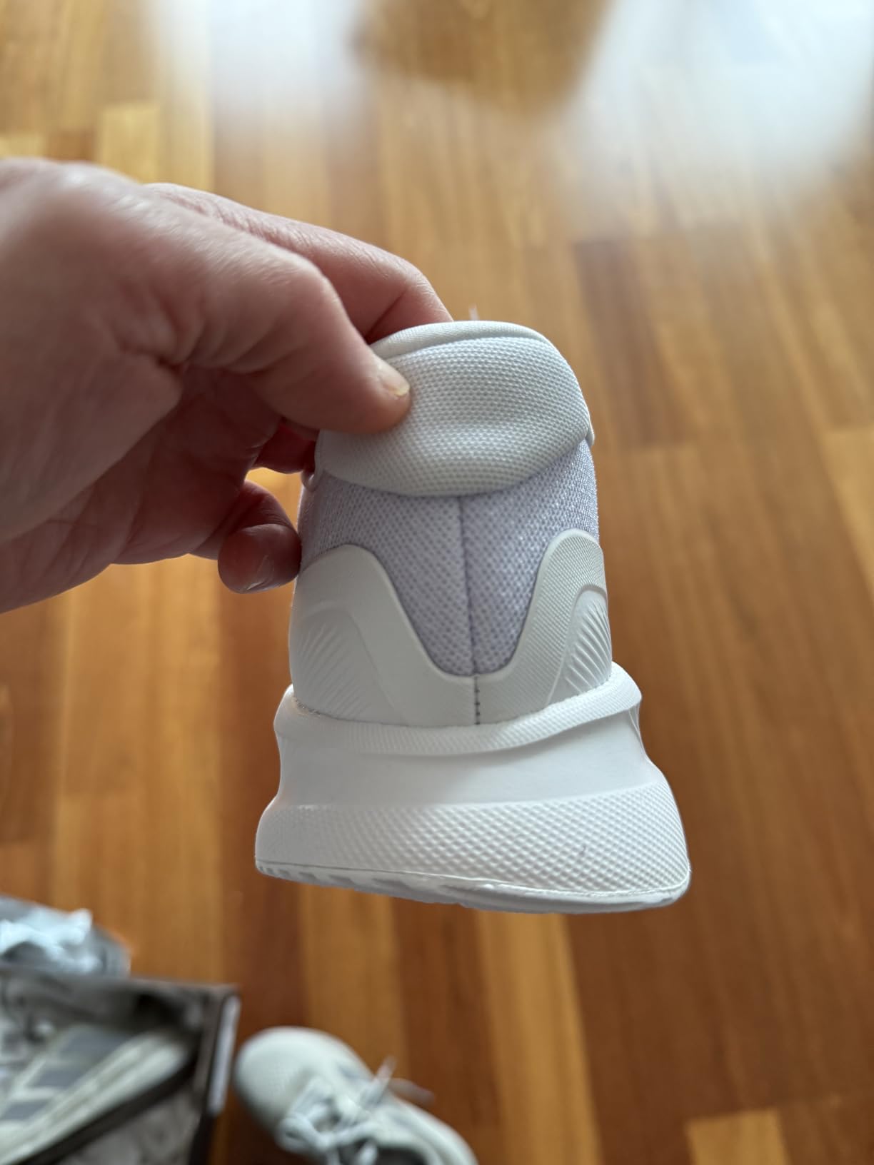 Sole view of Adidas Run Falcon 5 showing Adiwear outsole pattern and cushioning
