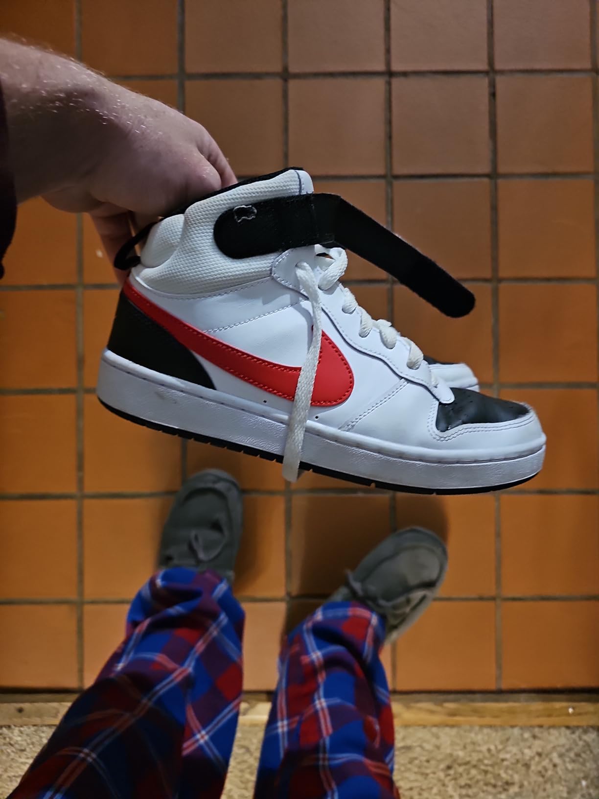 Nike Boy's Sneaker side profile showing mid-top ankle support and rubber outsole pattern
