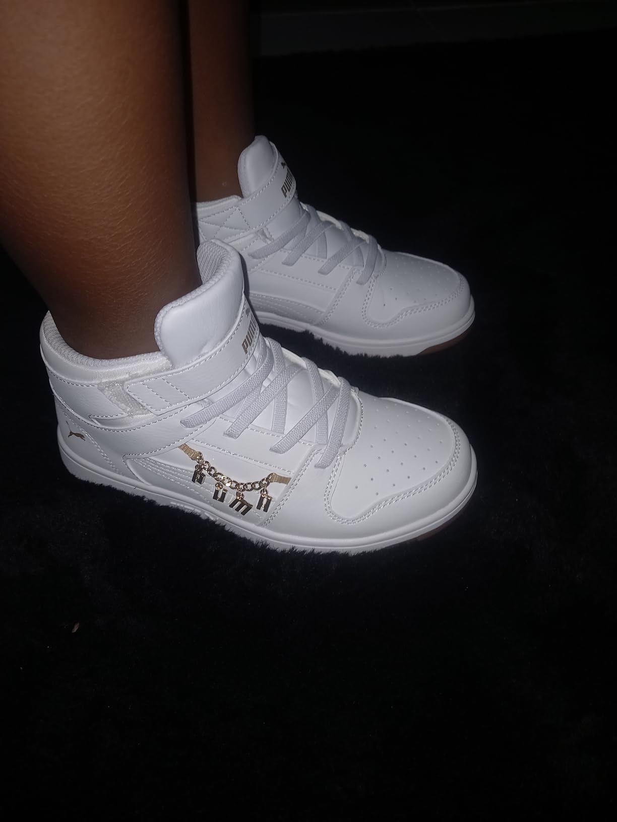 Close-up of PUMA Rebound Layup Mid showing perforated design and PUMA branding details