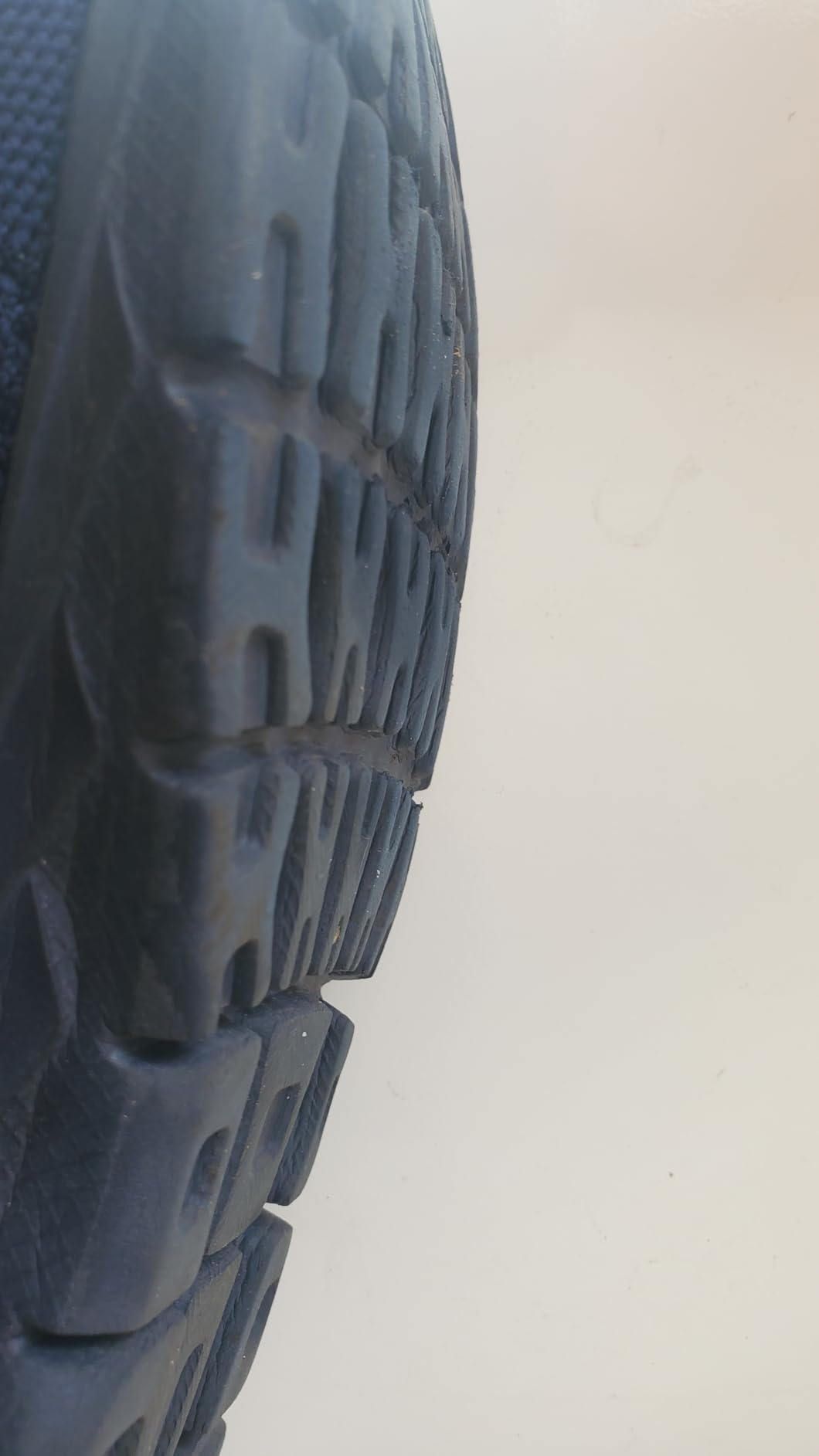 Close-up view of EVA mesh upper construction and lace-through design details