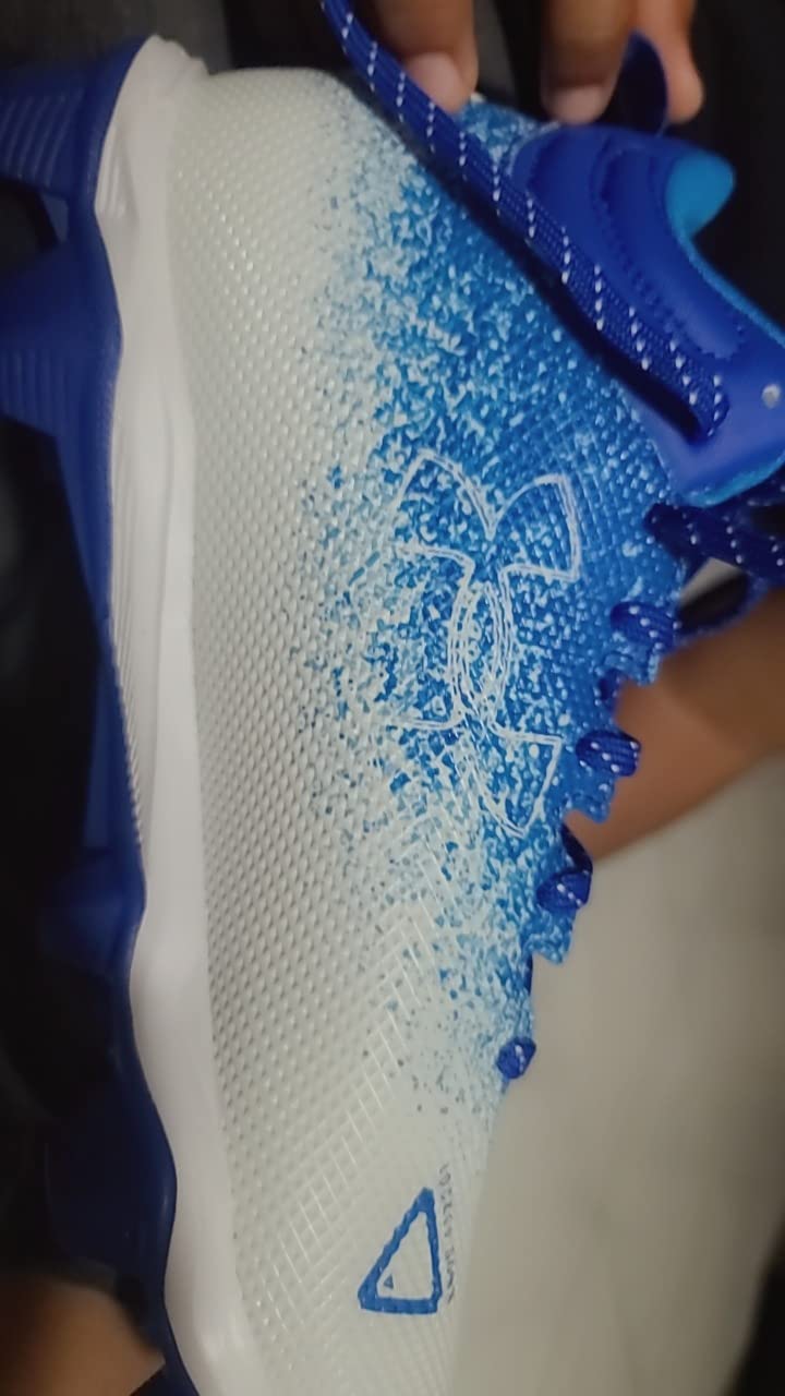 Side profile of Under Armour Spotlight Fran 2.0 showing ankle height and overall silhouette design for football performance