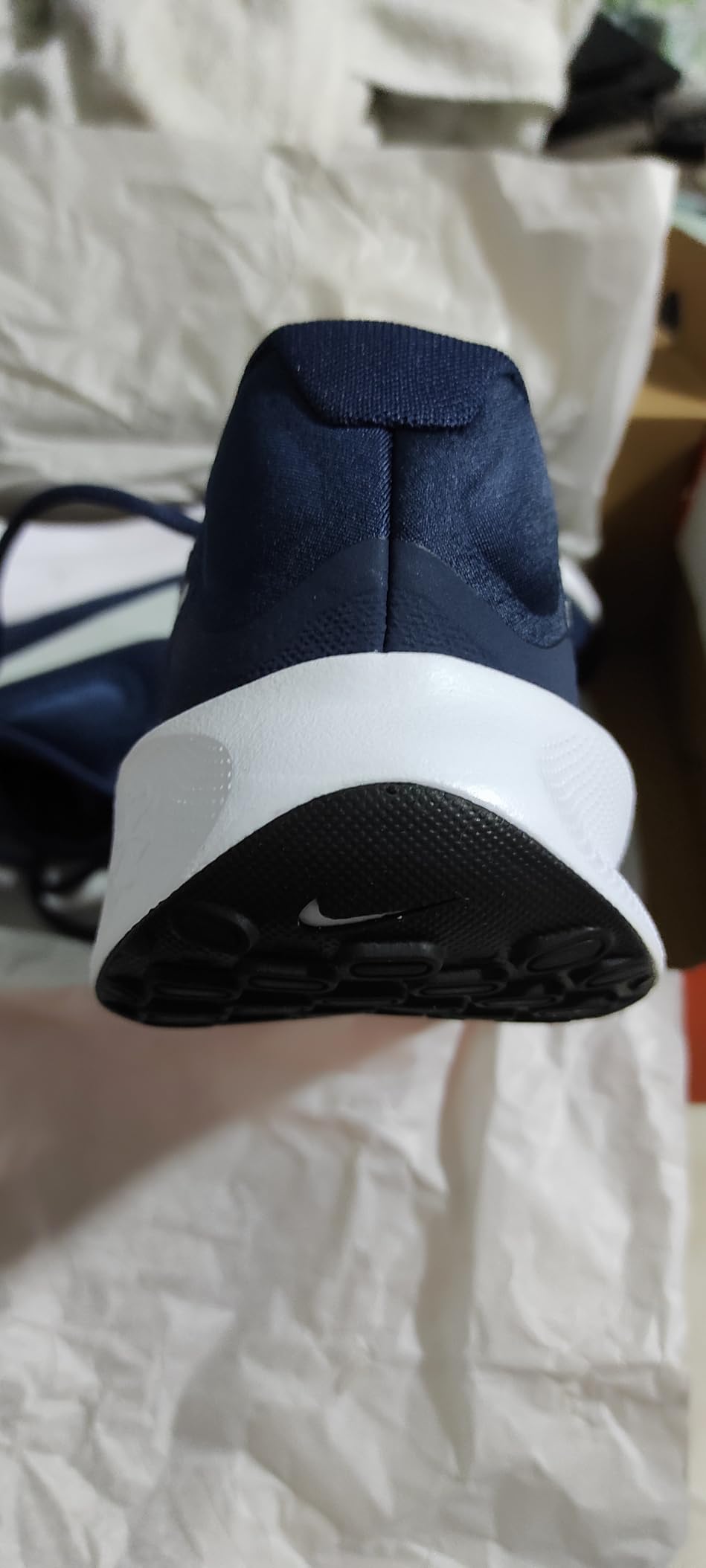 Nike Revolution 7 side profile showing breathable mesh upper and cushioning design