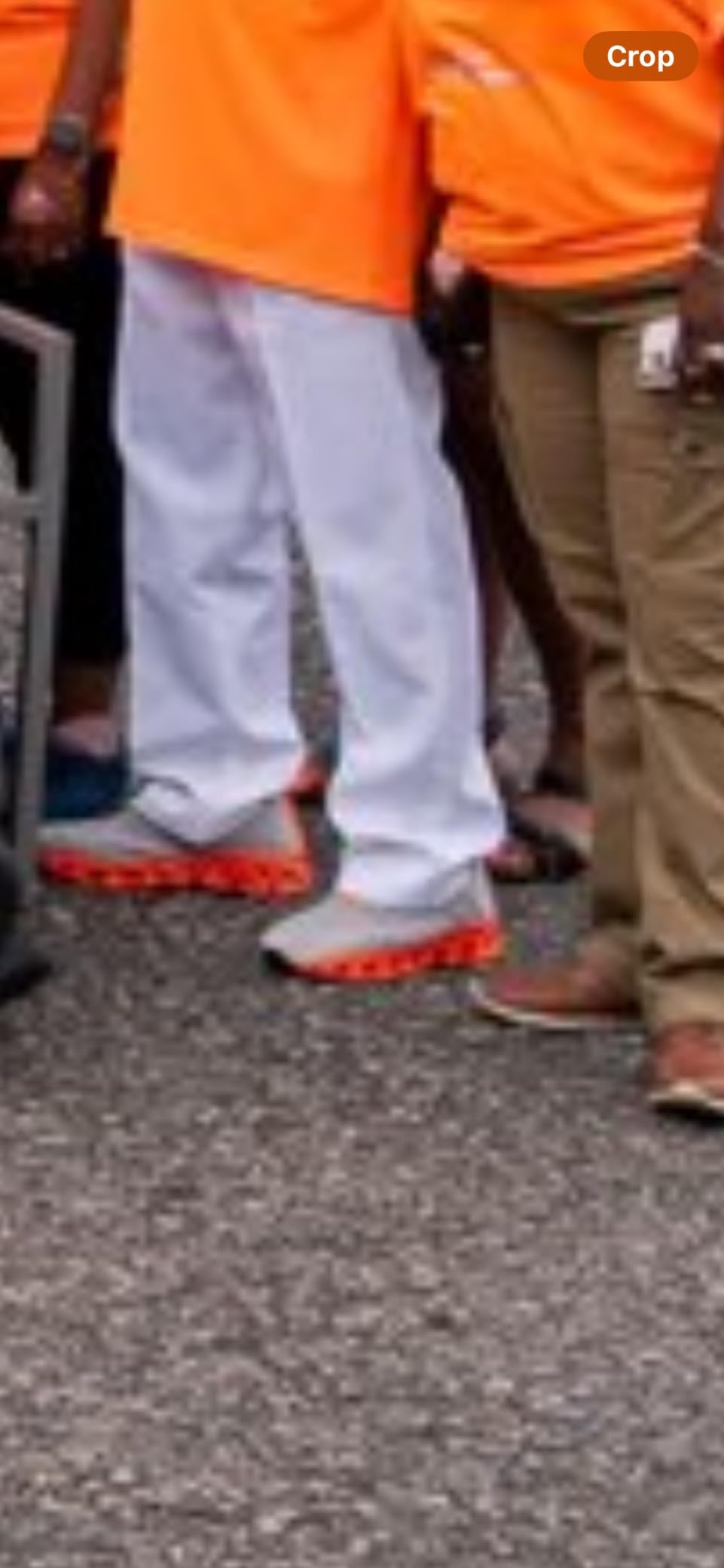 Mens blade sneakers worn with orange tee and white pants showing lifestyle styling