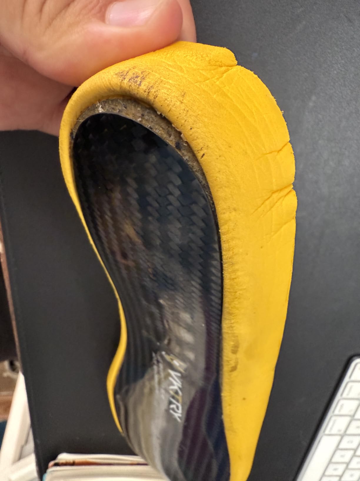 Close-up view of VKTRY Gold insole showing carbon fiber base construction and cushioned top layer