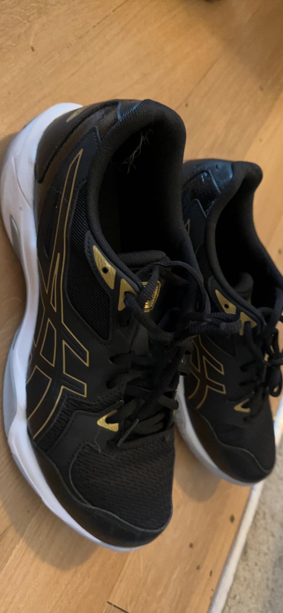 ASICS volleyball shoes in action showing court performance and style on hardwood floor