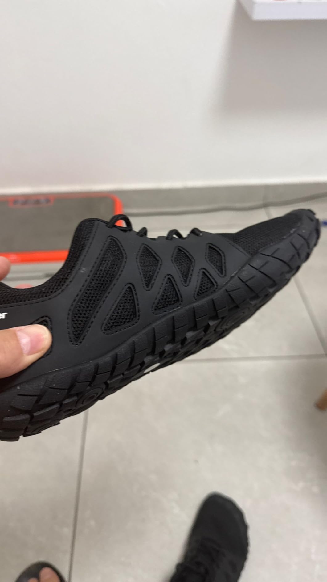 Comparison view showing wide toe box design versus traditional athletic shoe silhouette