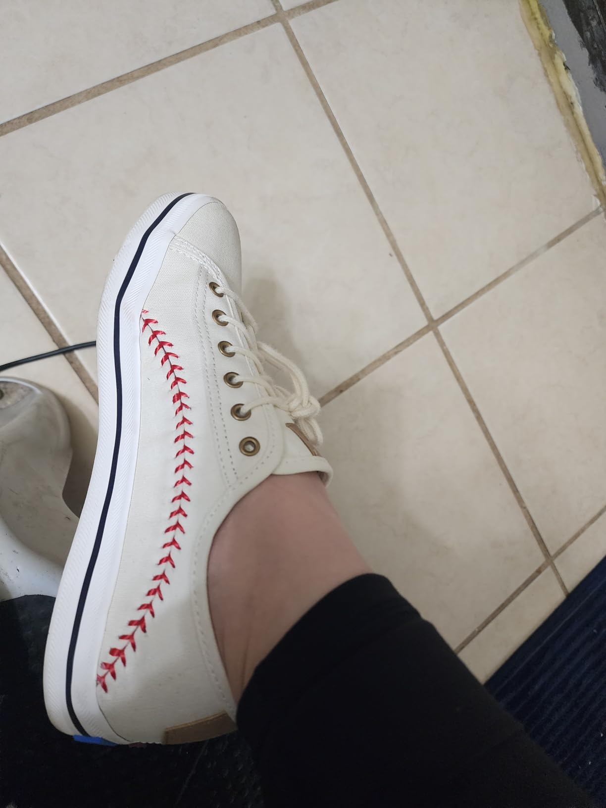 Detail shot of Keds sneaker construction showing baseball stitching and canvas quality