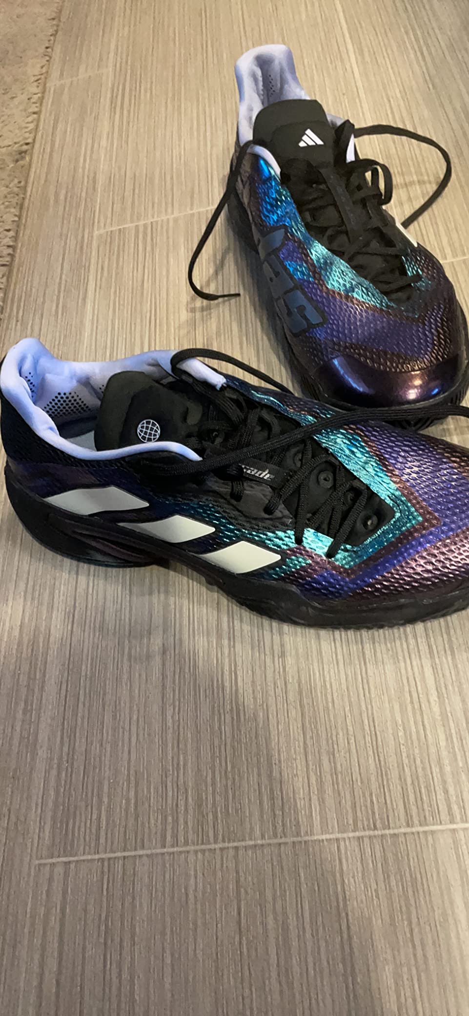 Close-up of Adidas Barricade Clay showing ADTUFF toe protection and rubber outsole pattern for clay courts