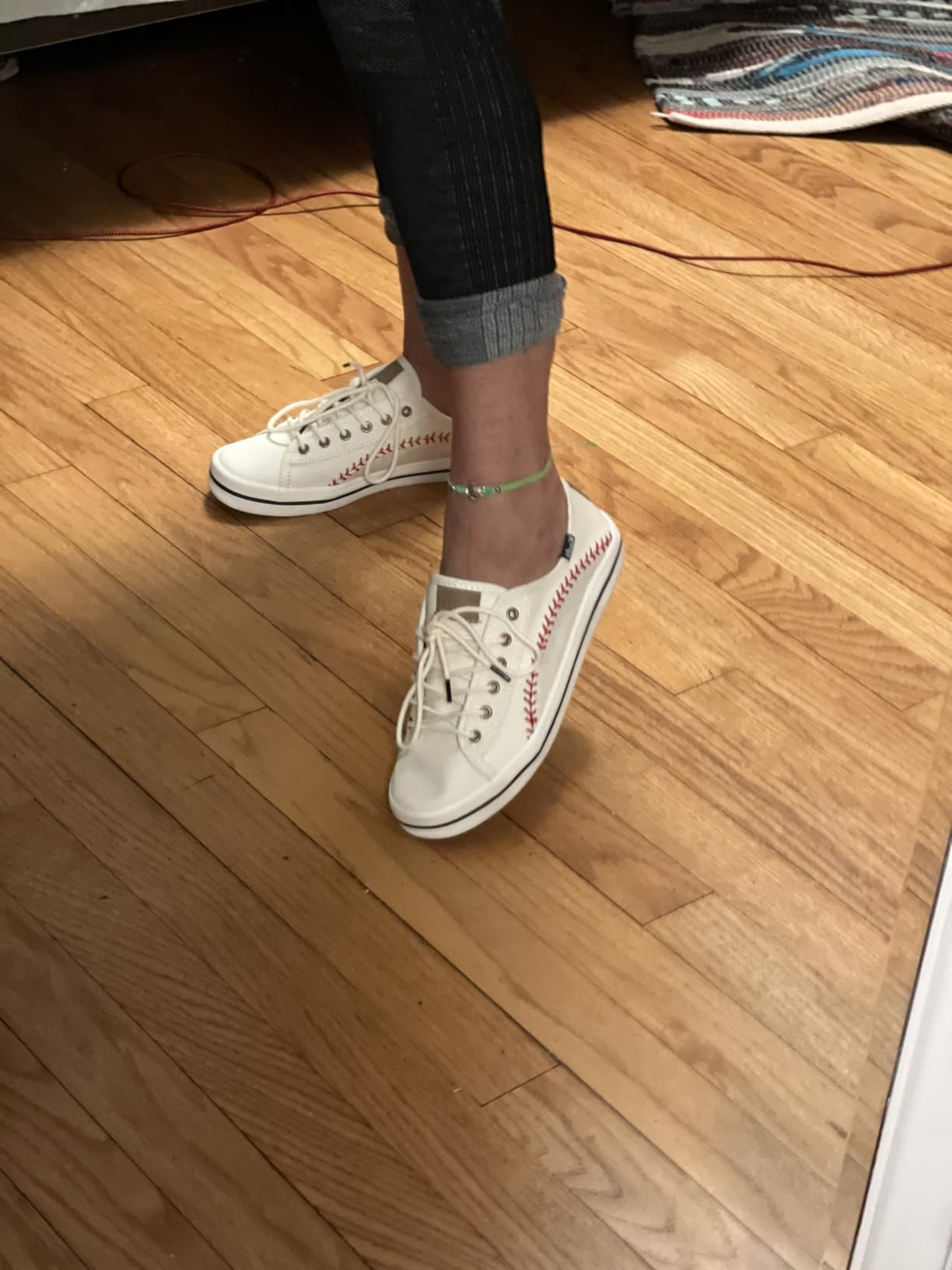 Close-up view of Keds baseball sneaker showing canvas upper and lacing system with extra brown laces