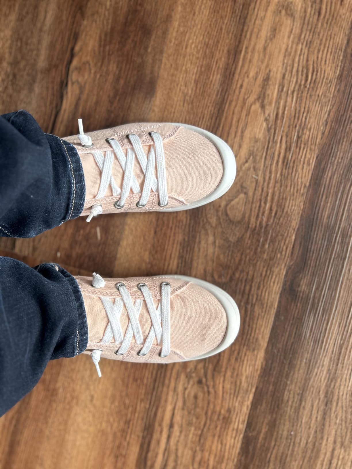 Pink/peach canvas sneakers showing actual color versus expected pink, demonstrating color accuracy issues