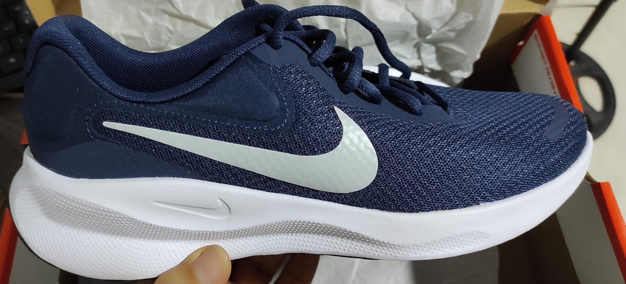 Nike Revolution 7 toe box and forefoot showing improved roominess compared to previous version