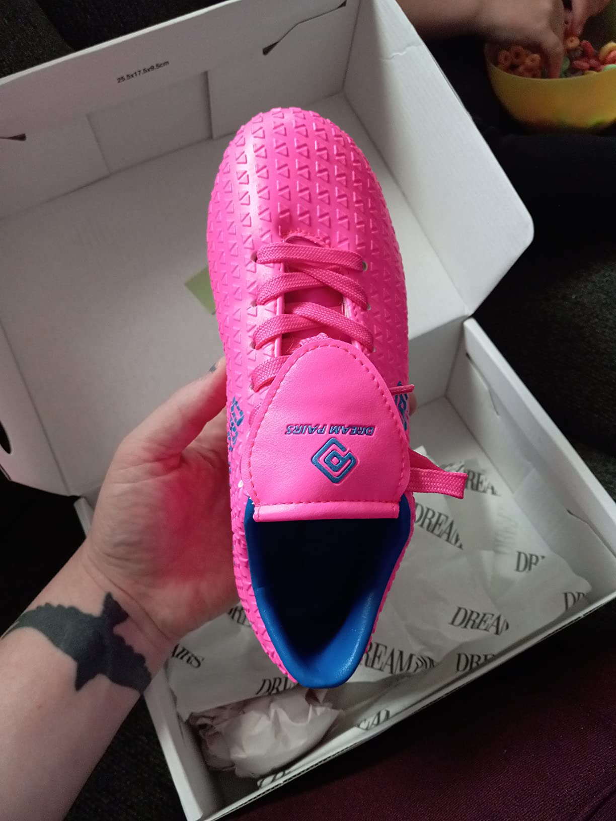 Multiple views of DREAM PAIRS soccer cleats showing construction quality and design details for youth players