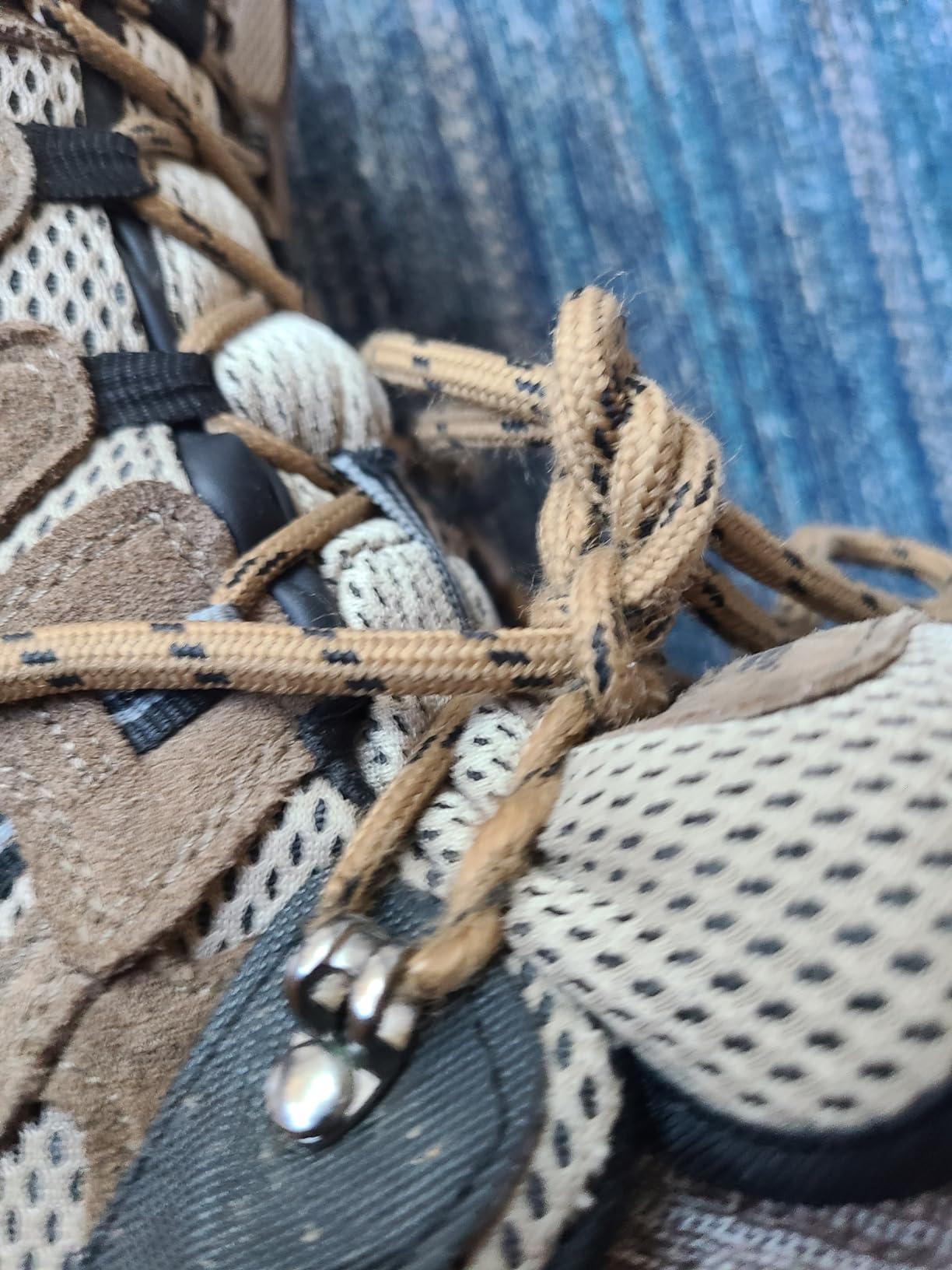 Detailed view of lace wear problem showing fraying from metal eyelets