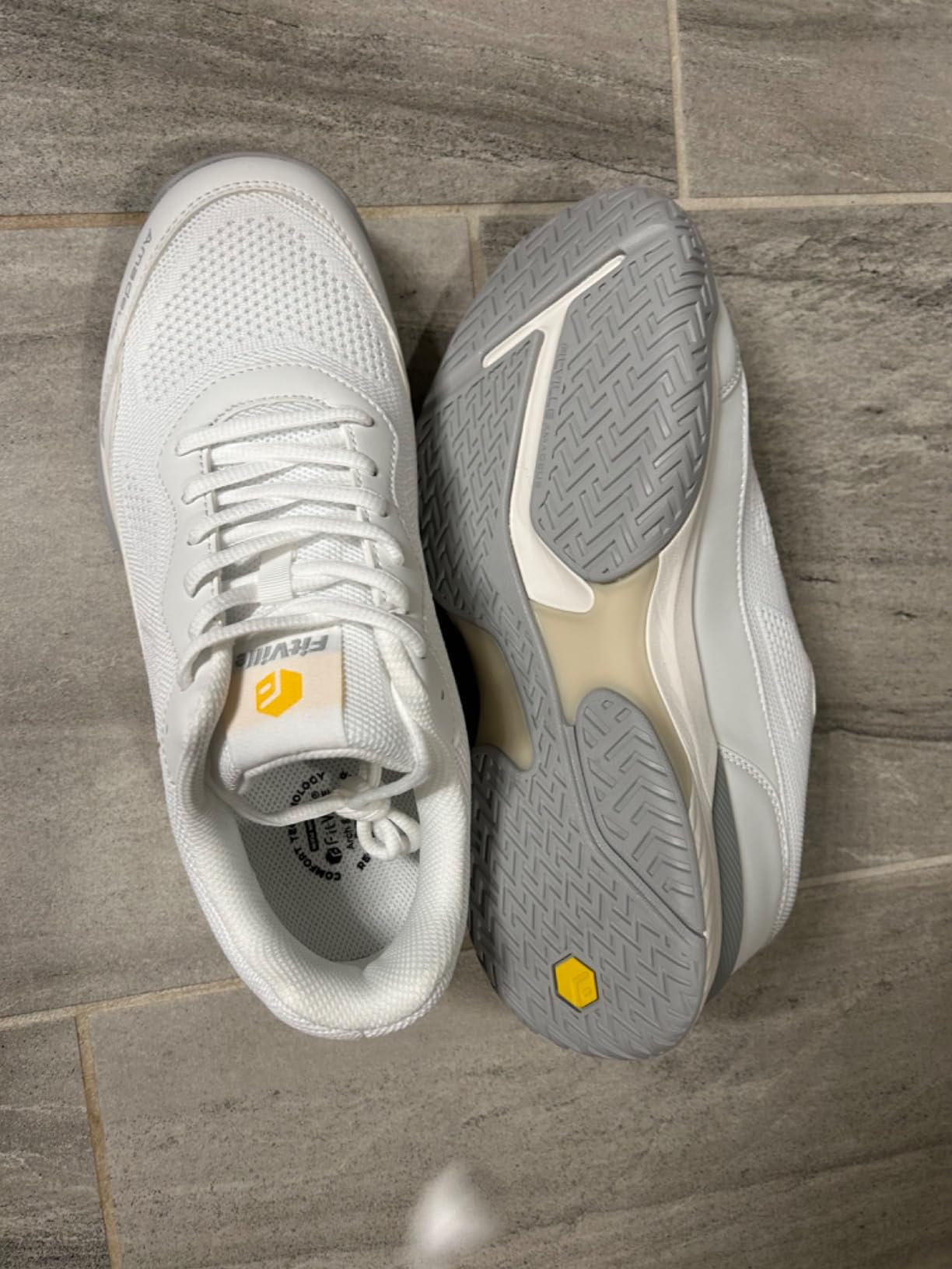 Group of pickleball players on court wearing various shoe brands including FitVille