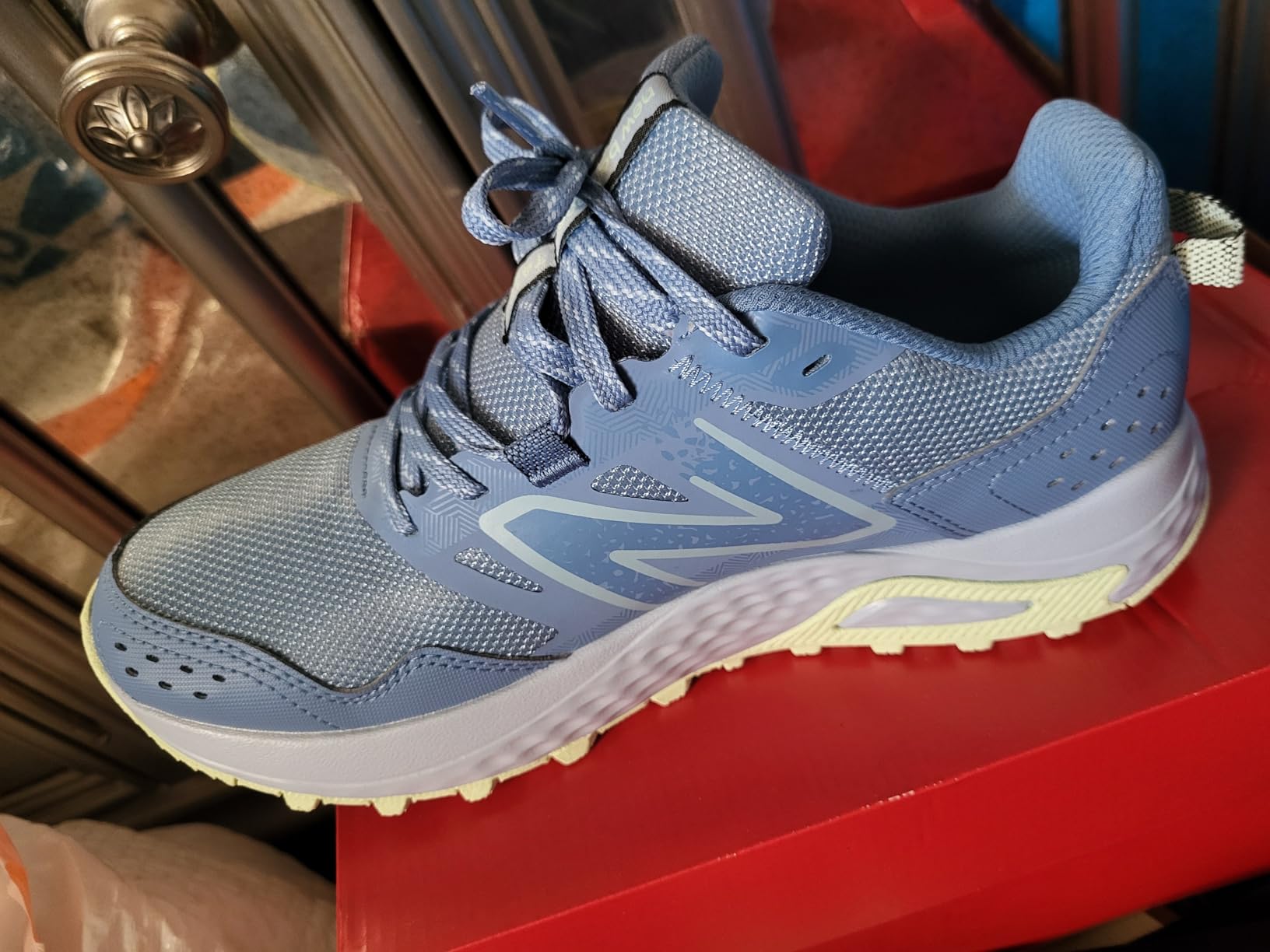 Bottom view of New Balance 410 V8 showing AT Tread outsole pattern and BIO Foam midsole