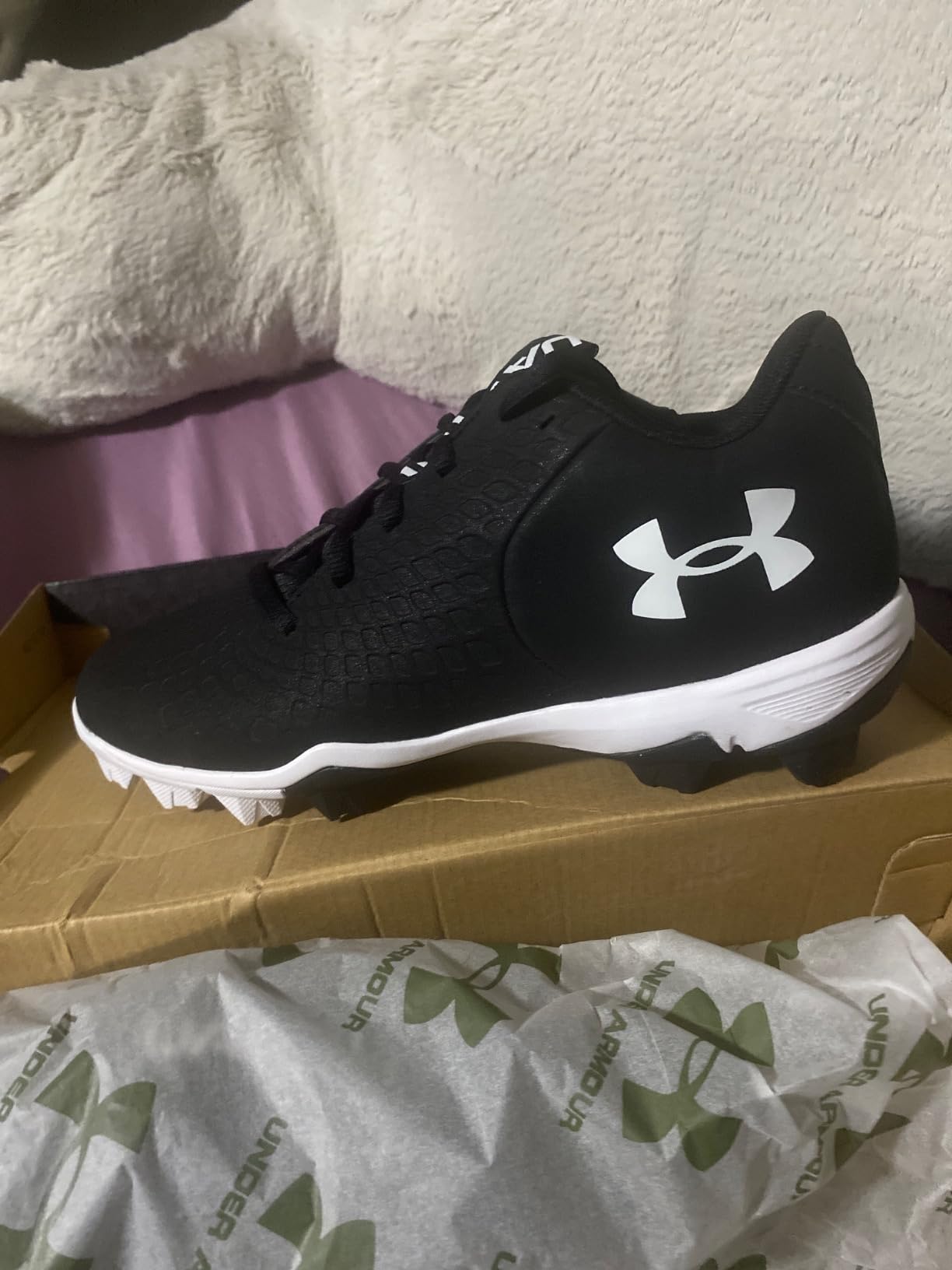 Under Armour Glyde 2.0 RM softball cleats showing molded rubber cleat pattern for field traction