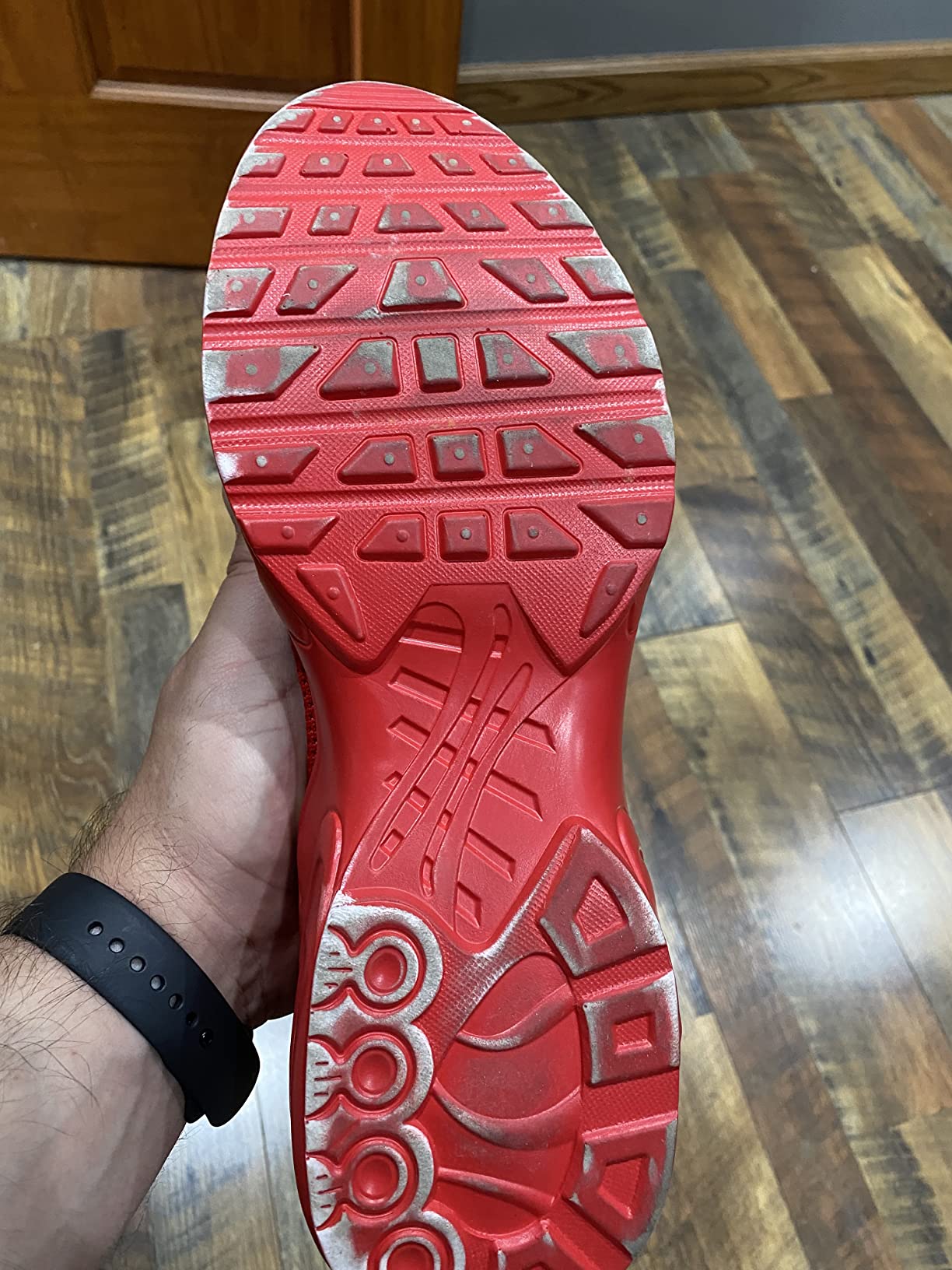 Close-up of sneaker wear patterns showing sole separation and upper mesh condition