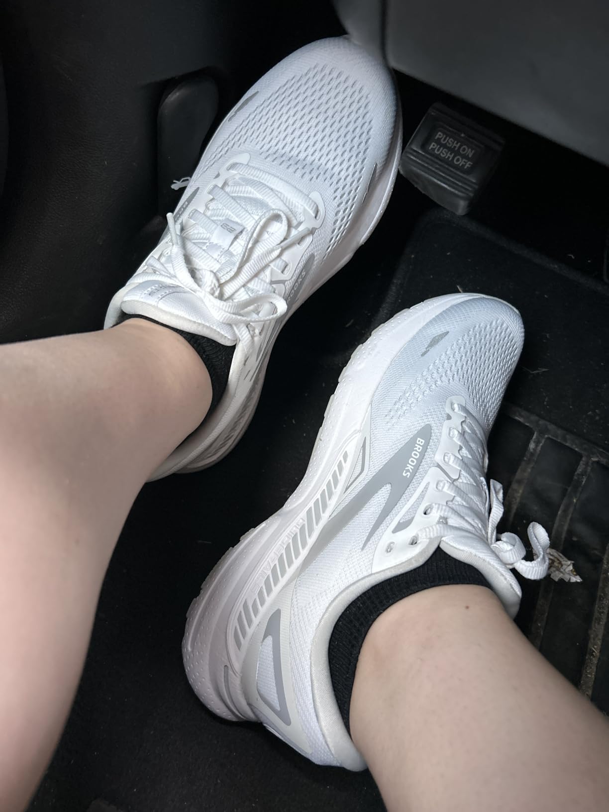 Brooks white women's running shoes showing clean design and durability features