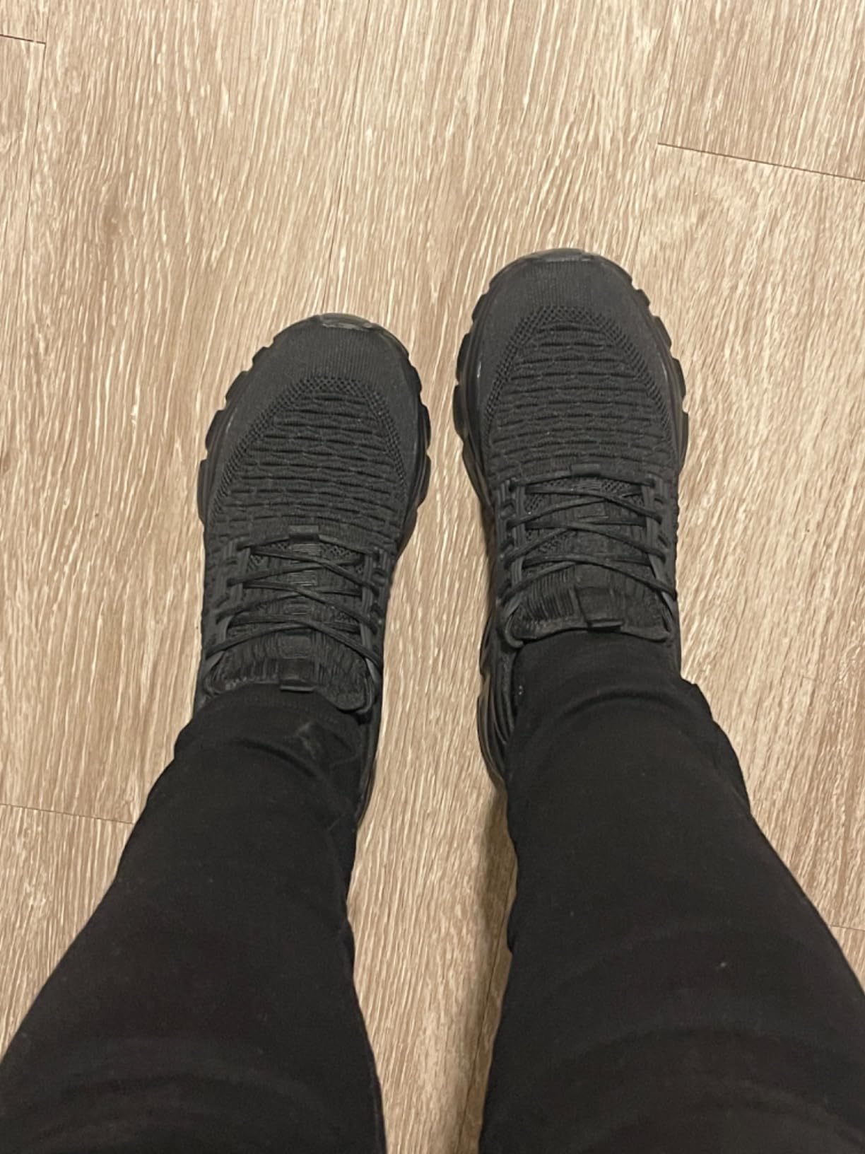 Close-up view of slip-on sneaker showing mesh upper construction and pull-tab design