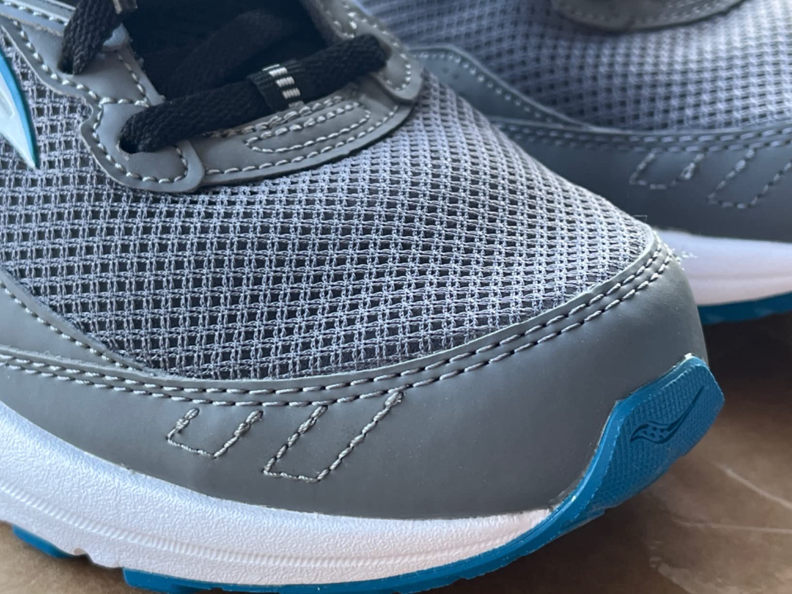 Side profile of Saucony Cohesion 15 showing midsole compression and heel counter design