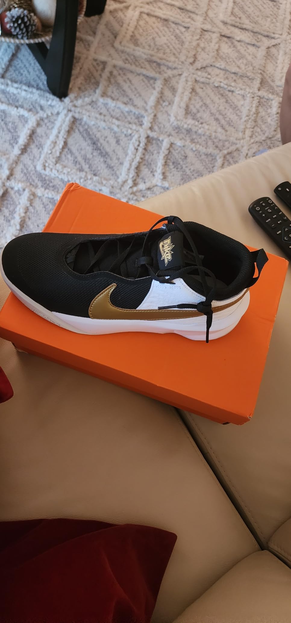 Close-up of Nike Team Hustle D 10 upper construction showing mesh panels and synthetic materials