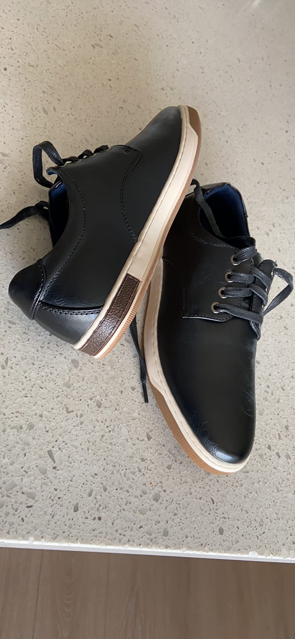 Jousen dress sneaker detail showing brown faux leather upper and white contrasting sole
